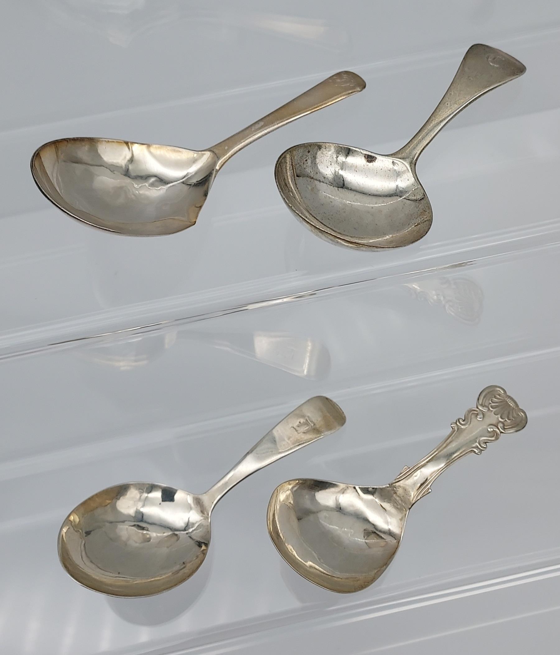 A Lot of four Georgian silver caddy spoons. [46.18grams]