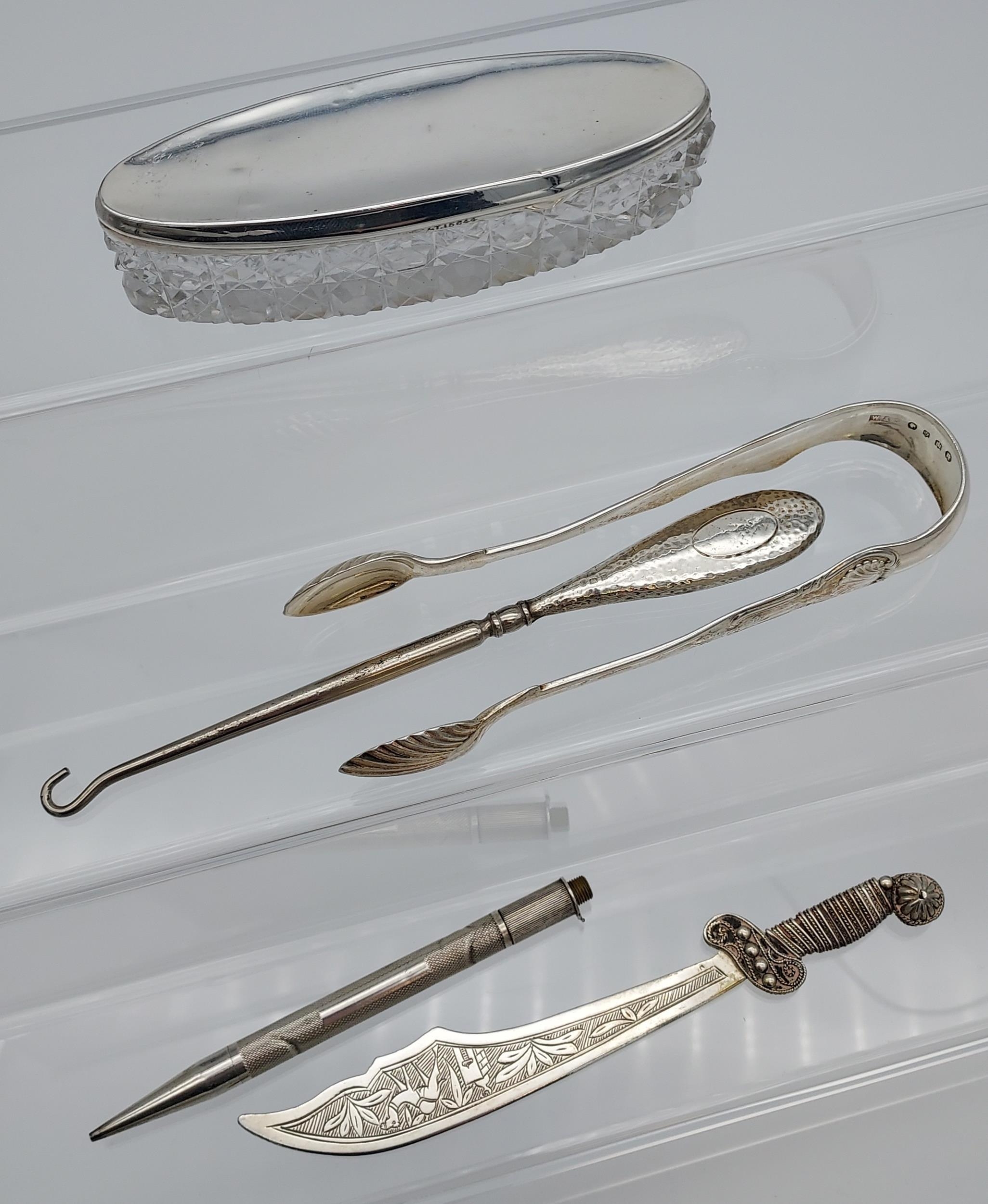 A Selection of silver items to include Victorian Edinburgh sugar tongs, silver handle button hook,