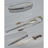 A Selection of silver items to include Victorian Edinburgh sugar tongs, silver handle button hook,