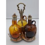 Antique E.P Three section tantalus decanter set. Three amber onion shape bottles with plated mounts.