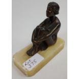 An Art Deco bronzed spelter, seated lady figurine on a marble base. [11cm in height]