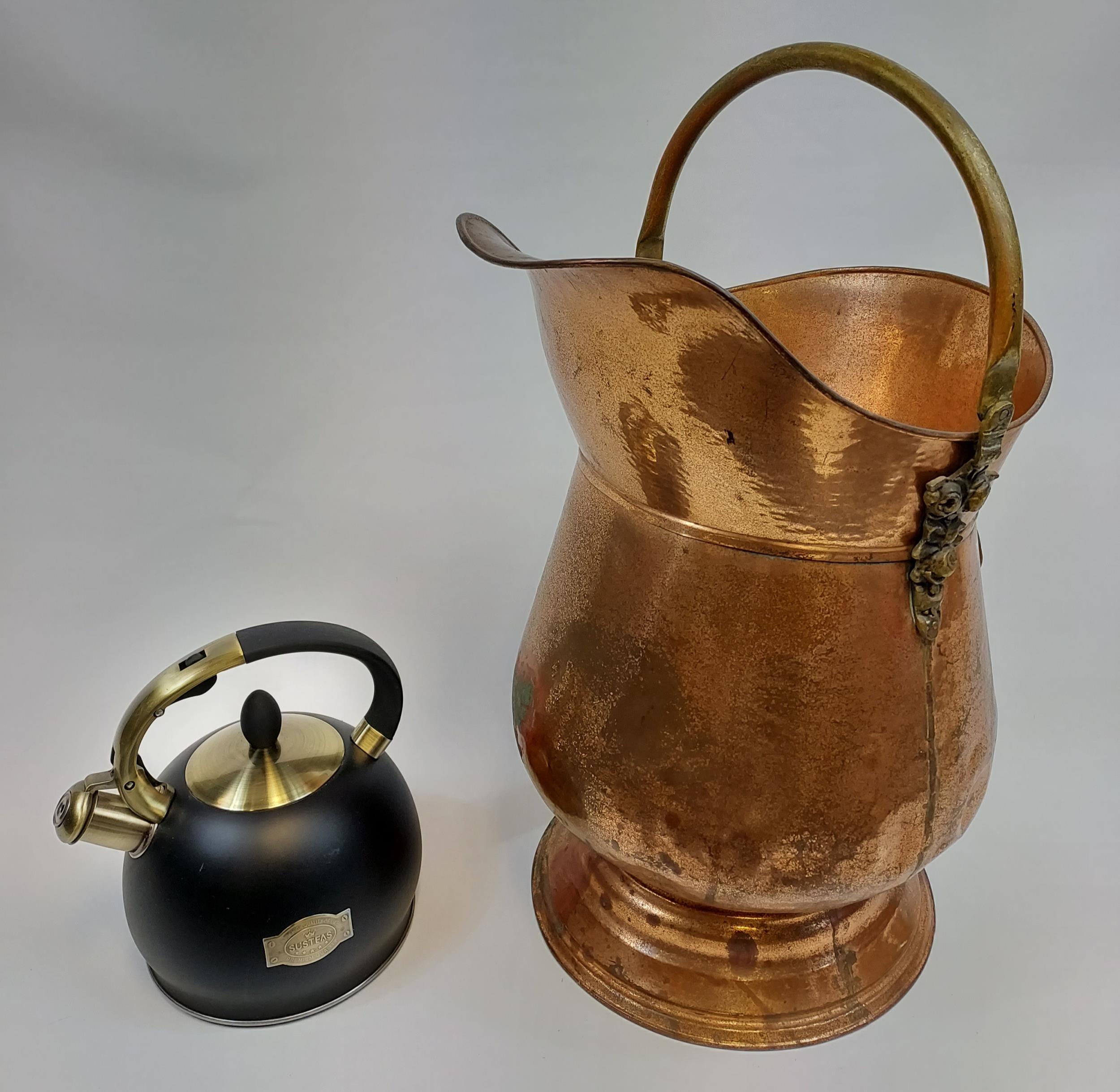 A Vintage brass and copper coal scuttle and Susteas stove top whistling tea kettle.
