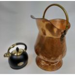 A Vintage brass and copper coal scuttle and Susteas stove top whistling tea kettle.