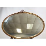 A 19TH Century regency style metal framed mirror, in an oval form. [60x78cm]
