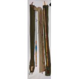 Three various fishing rods with bags.