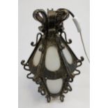 A Heavy wrought iron and frosted glass porch lantern. Working. [42cm in height]