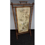 19th century bamboo framed screen enclosing an Asian embroidered silk panel, protected by a glass