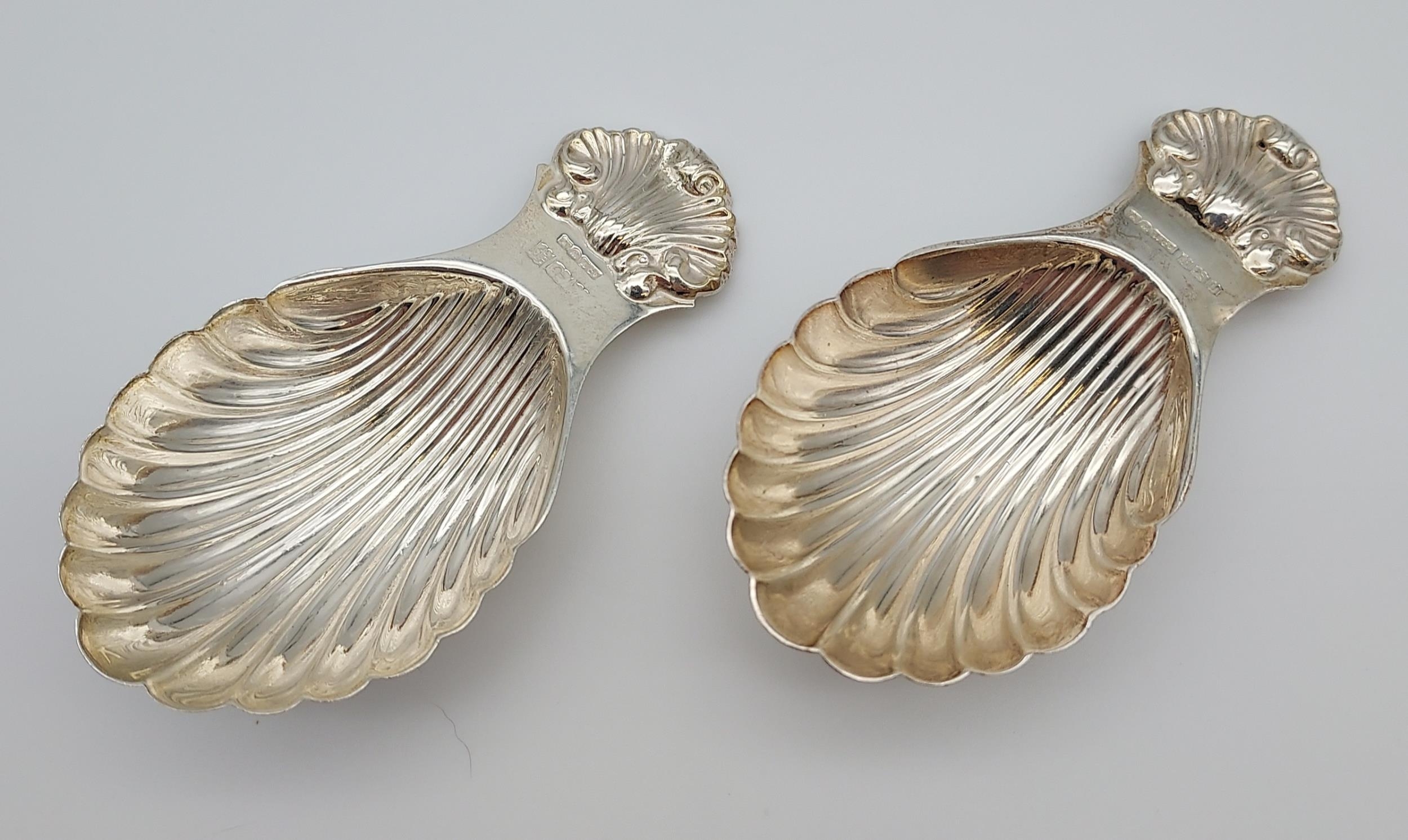 Two Birmingham silver caddy spoons, scalloped designs. [8cm in length] [42.19grams]