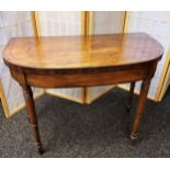 An early 19th century card table, fold over D-shaped top pivoting to open to a deep red surface,