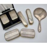 A Selection of silver hall marked dressing table brushes and hand mirror