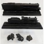 A Selection of coal carved sculptures to include two loco and tenders, two dogs and elephant.