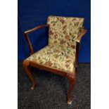 Antique arm chair with floral upholstery and stud finish.