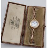 A 9ct gold vintage ladies watch with a 9ct gold elasticated strap and comes with original Mackay &