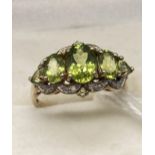 A 9ct gold diamond and green peridot ladies ring. [Ring size Q] [3.46 Grams]