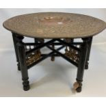 An Antique Indian/ Middle East copper raised relief table top with wooden base. [53cm in height,