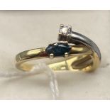 A Ladies 14ct gold two tone ring set with a single sapphire and single diamond. [4.46grams] [Ring