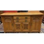 Oak dresser base, two central two handled drawers above two carved panelled doors leading to