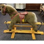 A Vintage childs rocking horse fitted upon a pine base. Craftsman made by Pegasus of Crewe England.