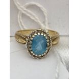 A ladies 9ct gold ring set with a large aquamarine stone surrounded by diamonds, [Ring size N] [3.