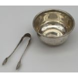 A Birks Sterling silver sugar bowl and pair of London silver sugar tongs. [76grams]
