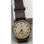 A Gent's Vintage 9ct gold cased Tudor watch. In a working condition.