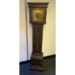 Antique brass face grandmother clock, In a fitted dark oak body. Comes with pendulum and key.