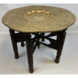 Antique Indian/ Middle east gilt brass top table with wooden carved trestle base. [50cm in height,