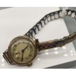 A Ladies Uno 9ct gold cased watch with plated elasticated strap. In a working condition.