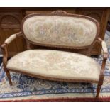 Parlour settee, upholstered oval back over cushioned seat raised on turned column legs, with open