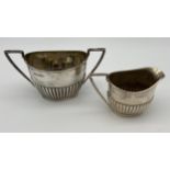 A Sheffield silver cream and sugar bowl produced by Walker & Hall. [240grams]