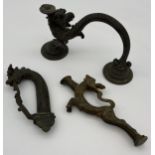 A Tibetan Bronze dragon head sword hilt, Bronze dragon handle and one other item.