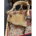 A 19th century smokers arm chair with bergere seat area.