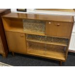 Mid century cabinet, designed with glass sliding doors leading to shelved display sections and two