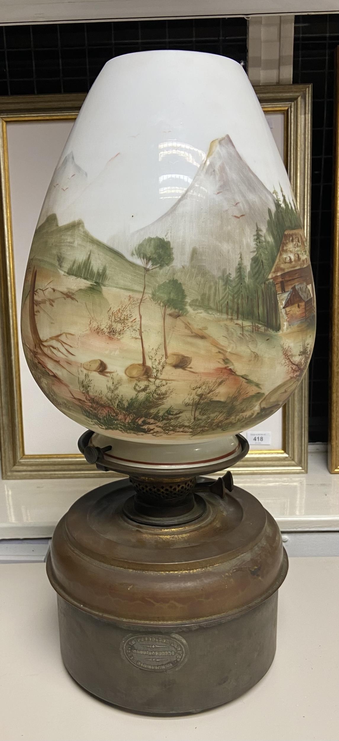 A Large antique paraffin lamp designed with a hand painted glass shade. [shade has a hairline crack]