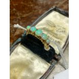 An 18ct gold ladies ring set with 5 black opals [Ring size N] [4.11Grams][chip to centre opal] Comes