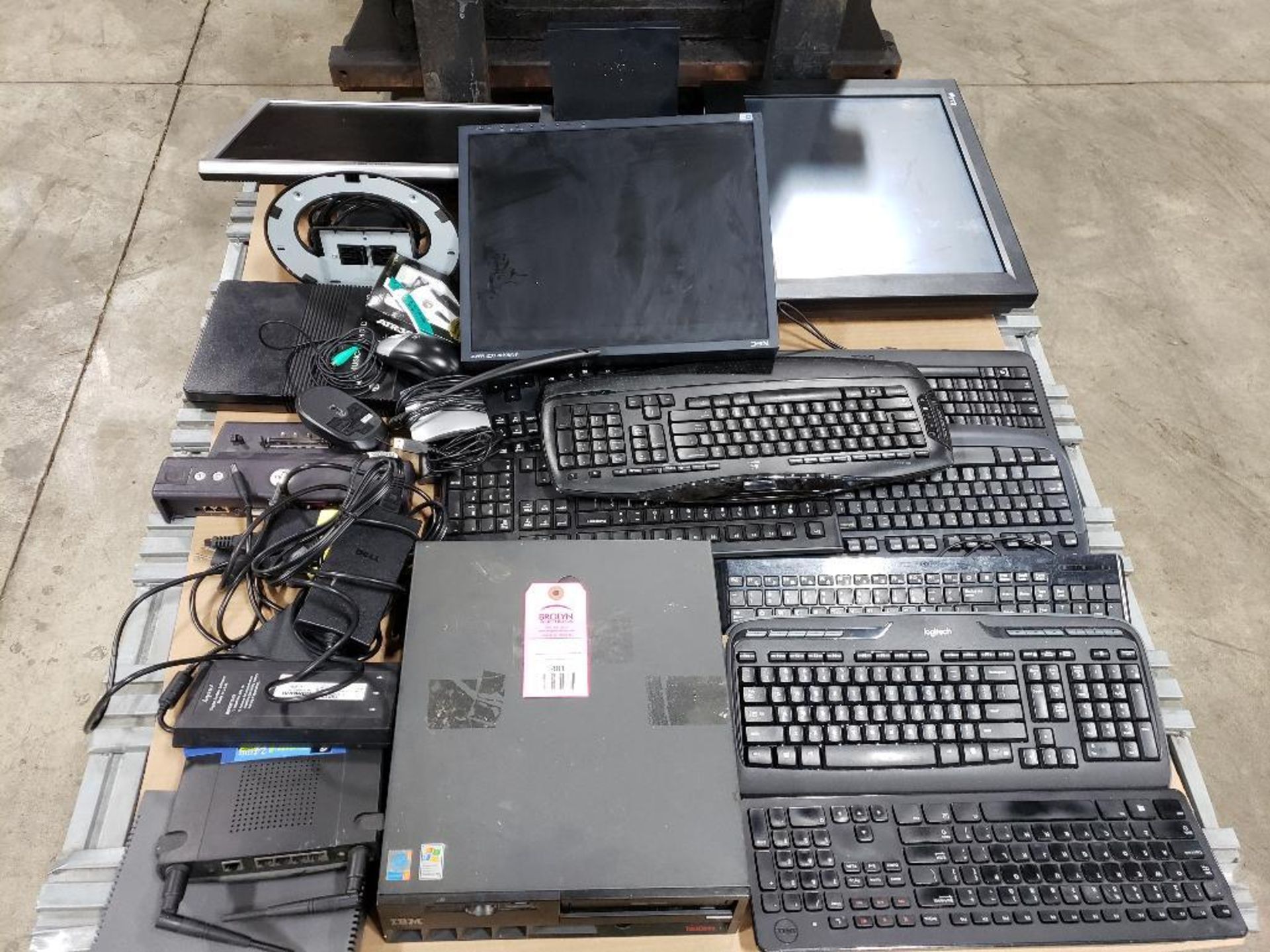 Assorted monitors, keyboards, and other computer hardware.