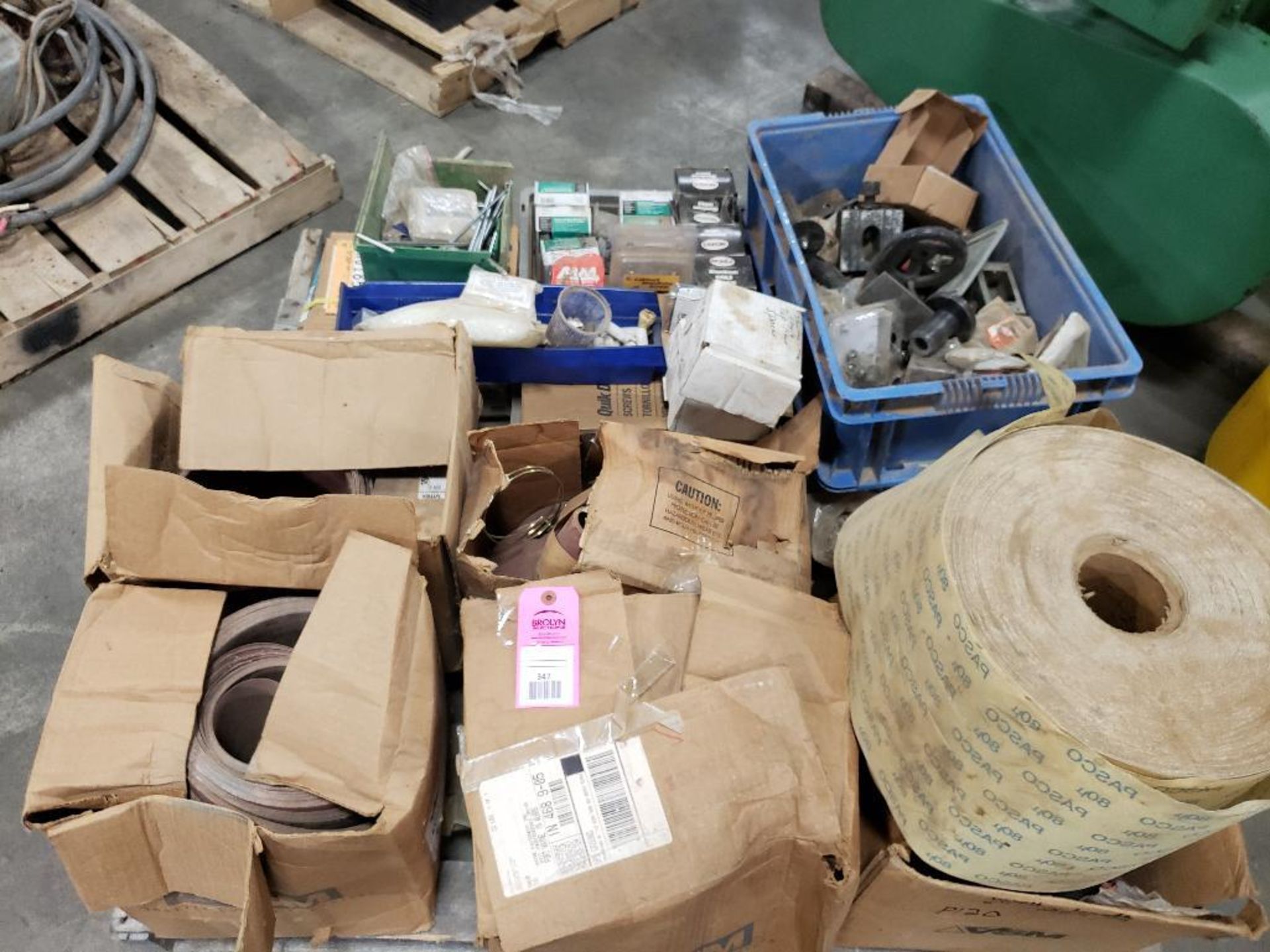 Pallet of assorted parts, sand paper, and hardware.