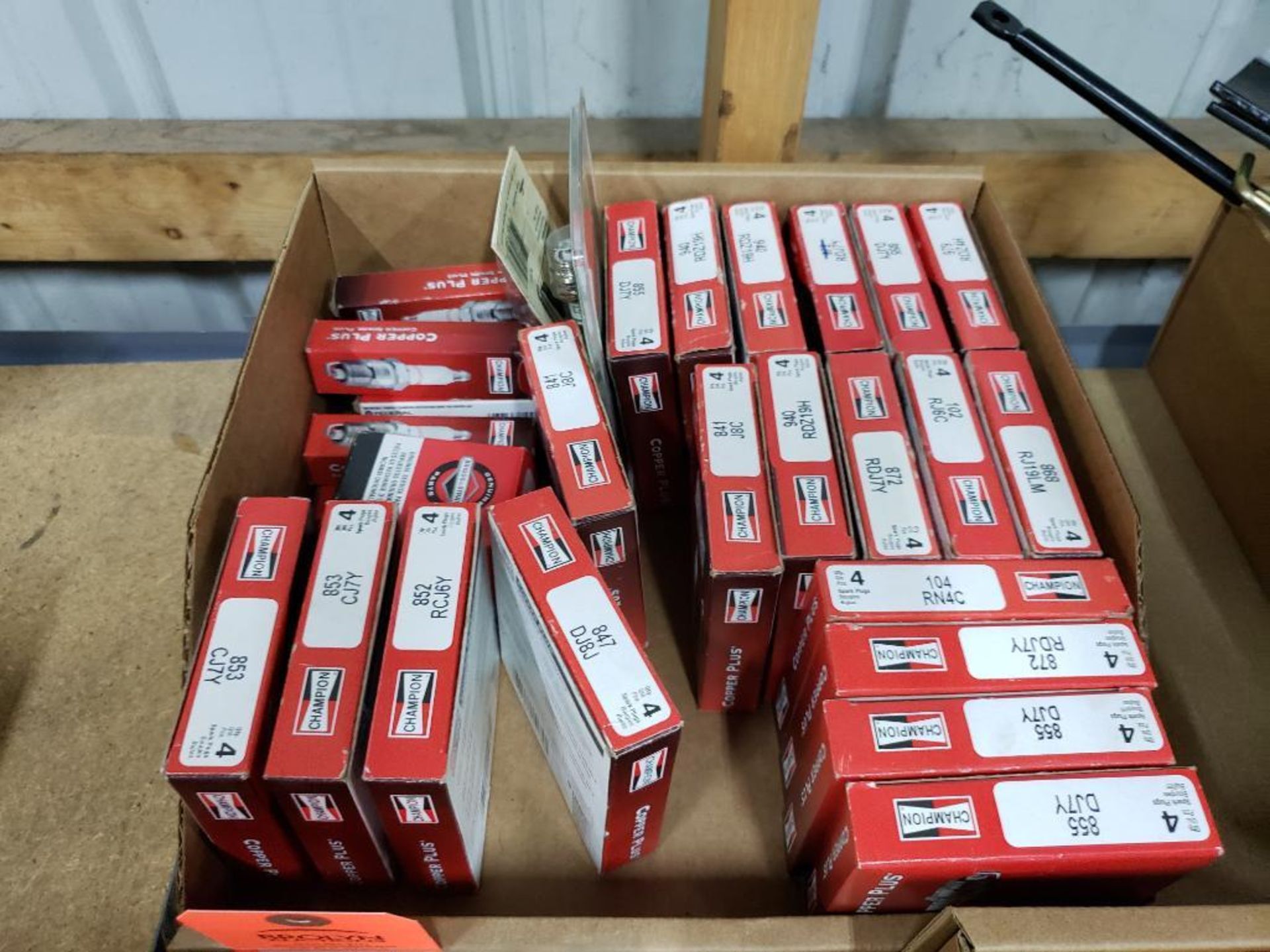 Large assortment of spark plugs. New in box.