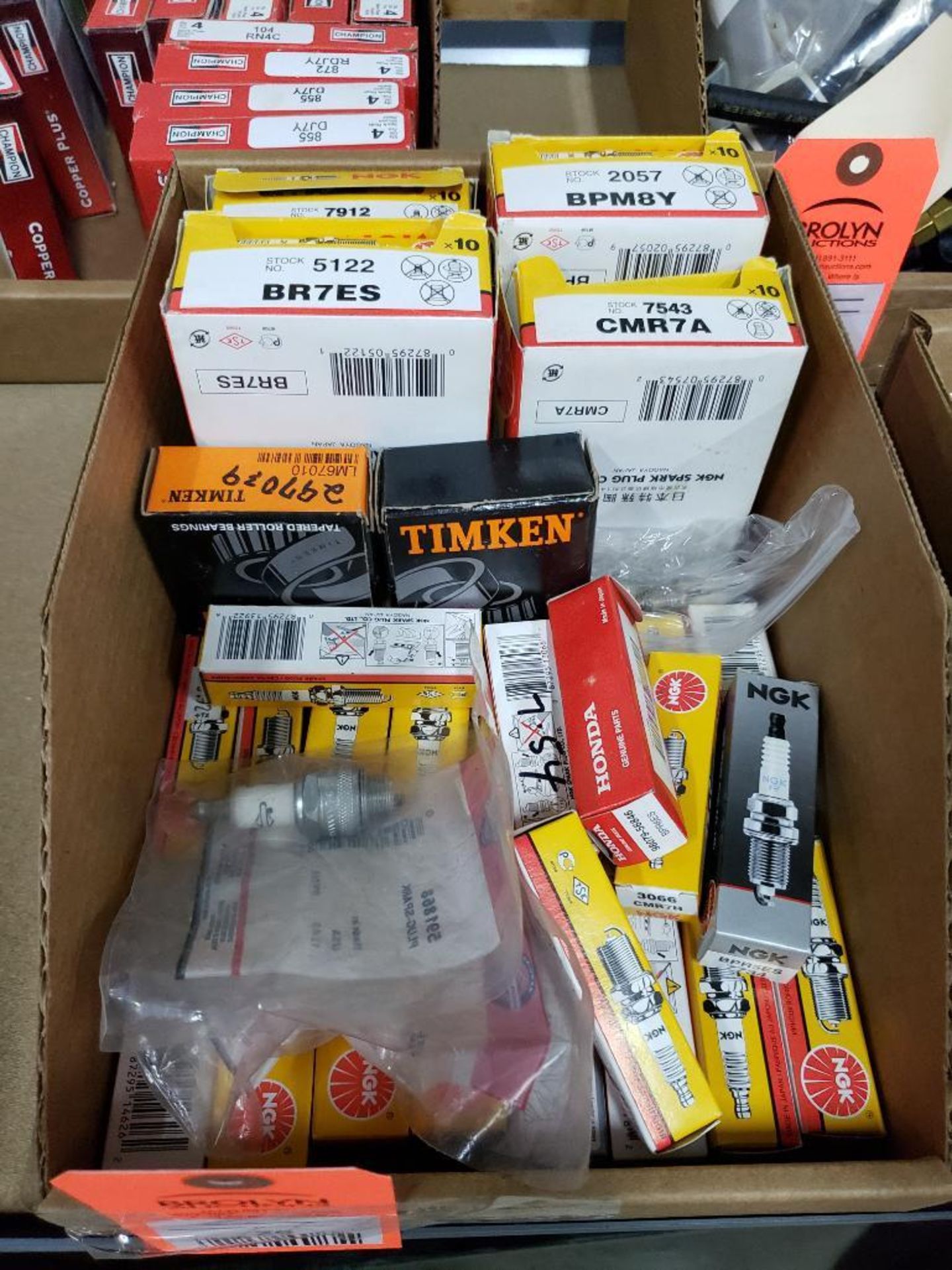 Large assortment of spark plugs. New in box.