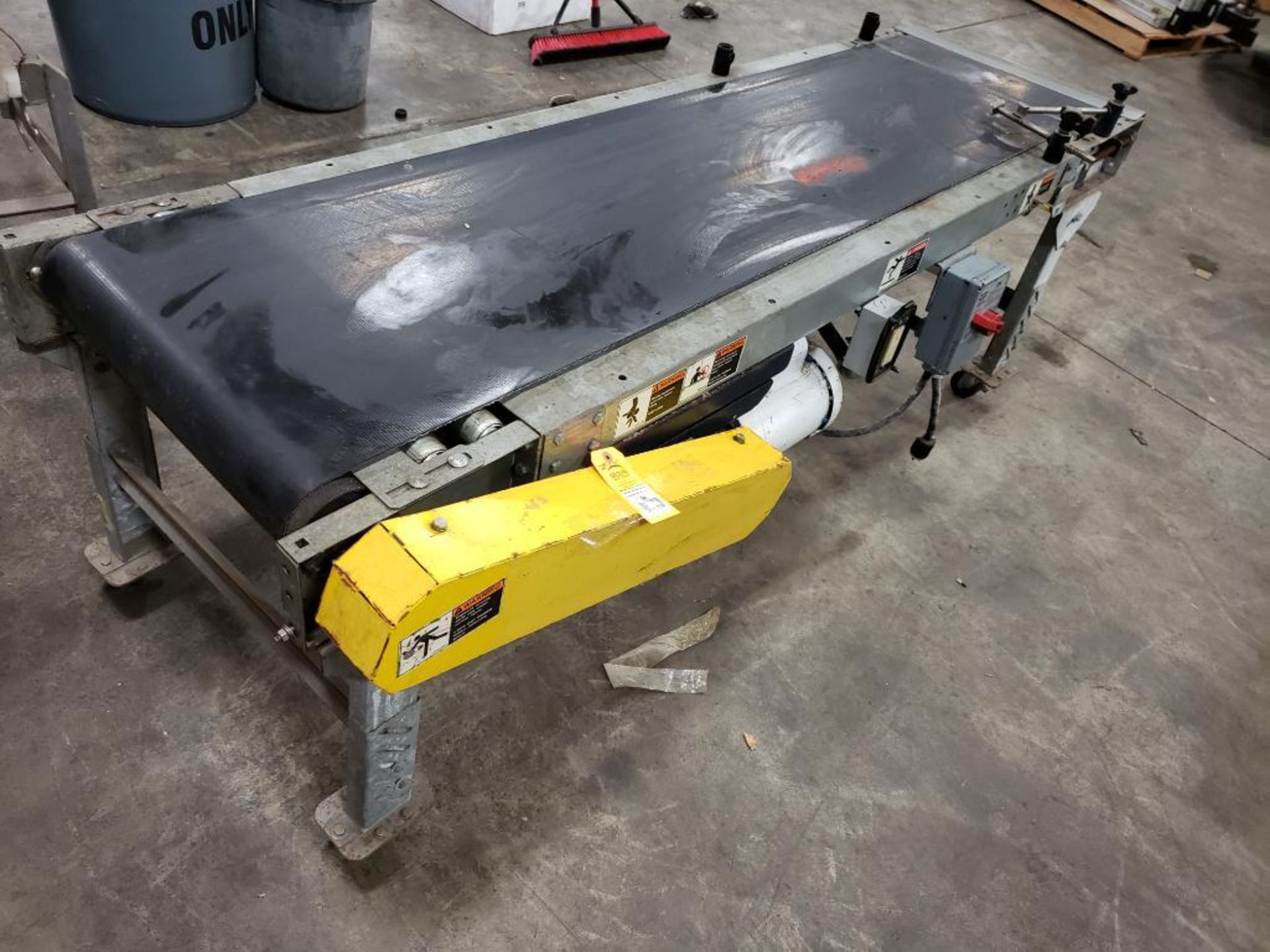 Power conveyor on casters. 80" long x 20" wide.