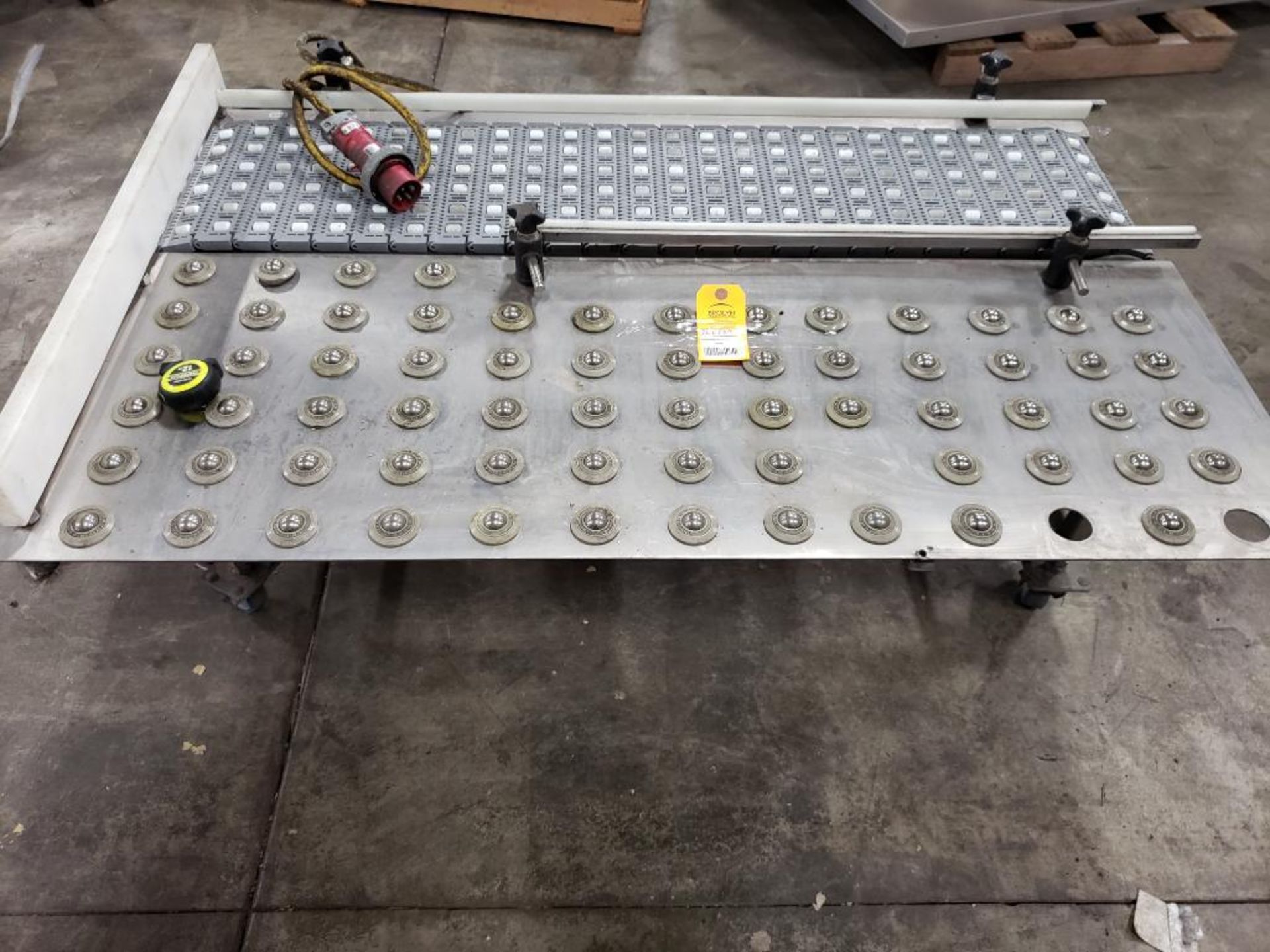 Food grade washdown power conveyor on casters with roller side table. Overall size 53" long x 32" w