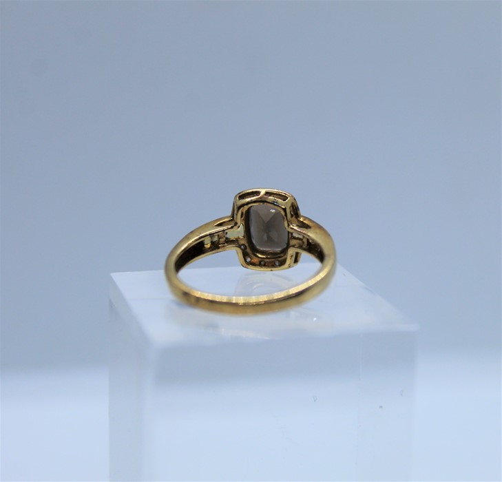 9ct Gold Gem Set and Diamond Ladies Ring, The Emerald cut stone flanked with Diamond chips, - Image 3 of 3