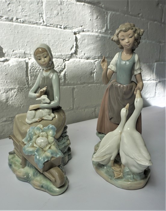 Lladro Figure of a Girl Holding a Lamb, 24cm high, With a similar Nao Figure, 27cm high, (2)