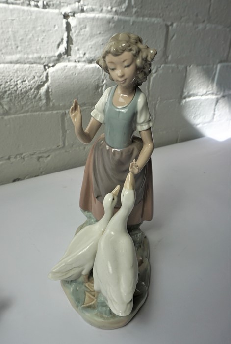 Lladro Figure of a Girl Holding a Lamb, 24cm high, With a similar Nao Figure, 27cm high, (2) - Image 3 of 4