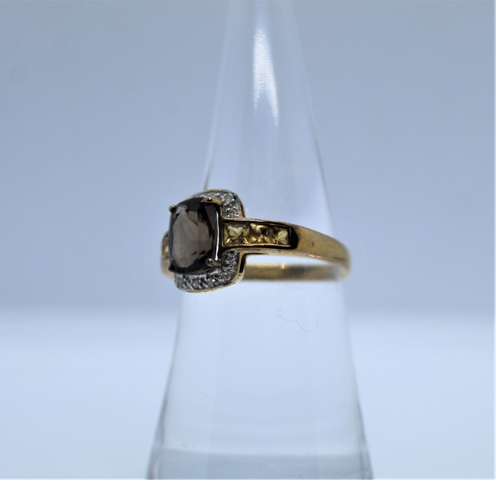 9ct Gold Gem Set and Diamond Ladies Ring, The Emerald cut stone flanked with Diamond chips, - Image 2 of 3