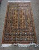 Afghan style Rug, Decorated with Geometric motifs on a rust ground, 137cm x 75cm