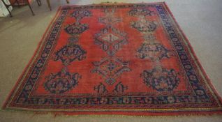 Turkish Rug, Decorated with Geometric Medallions on a red ground, 247cm x 223cm
