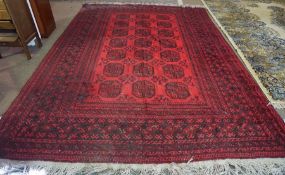 Turkish Carpet, Decorated with seven rows of three Geometric medallions on a red ground, 322cm x