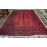 Turkish Carpet, Decorated with seven rows of three Geometric medallions on a red ground, 322cm x