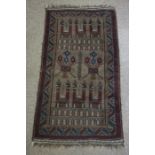 Afghan Hand Knotted Rug, Decorated with Geometric palaces and motifs on a red ground, 146cm x 80cm